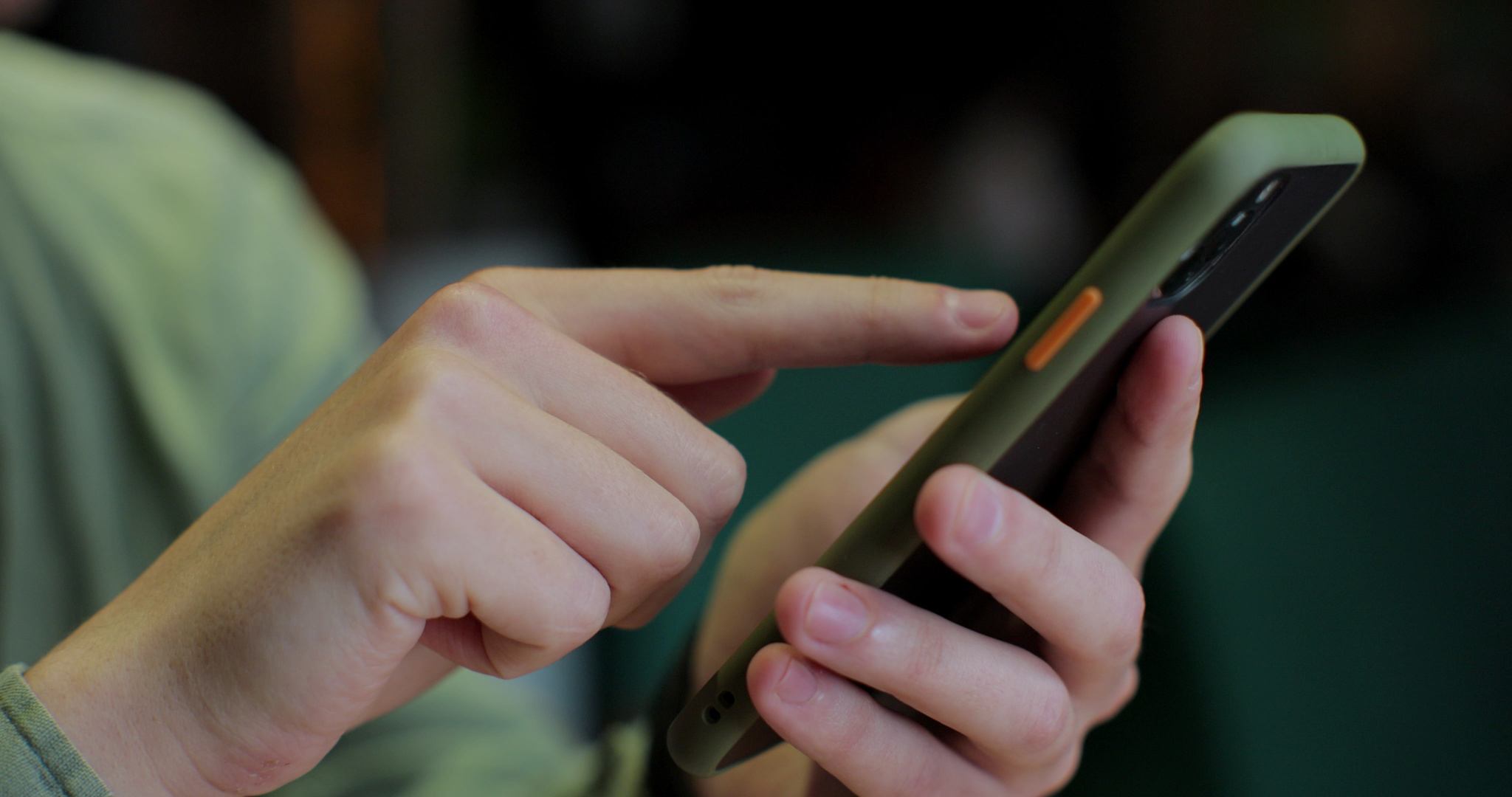 Man holding a smartphone in his hands and using an app. Hand